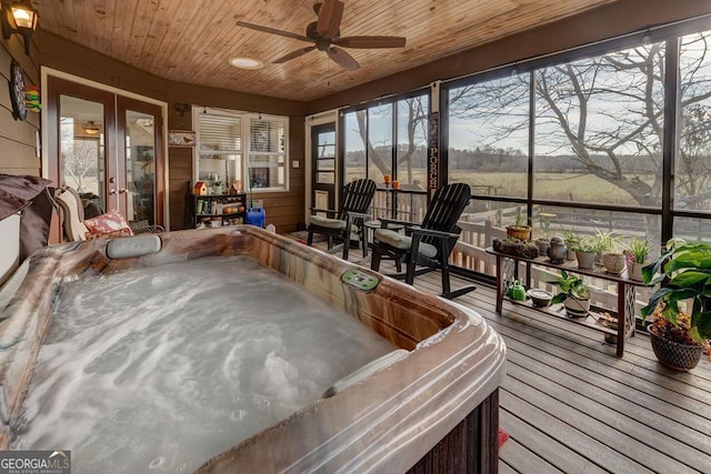 sunroom with wood ceiling, french doors, a rural view, ceiling fan, and a jacuzzi