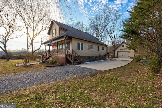 view of property exterior featuring a garage, a yard, an outdoor structure, and a porch