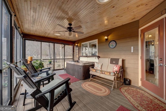 sunroom / solarium with ceiling fan and wooden ceiling