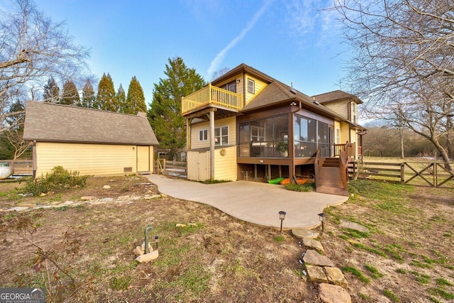 back of property featuring a patio area and a sunroom