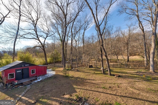 view of yard with a storage unit and a rural view