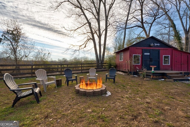 view of yard with a fire pit and an outbuilding