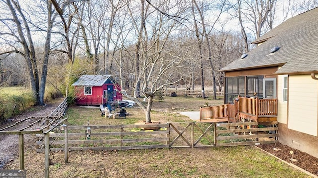 view of yard with a wooden deck and a sunroom