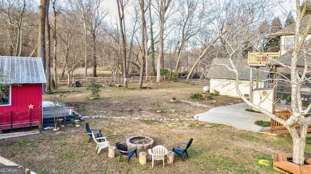 view of yard with an outdoor fire pit and an outbuilding