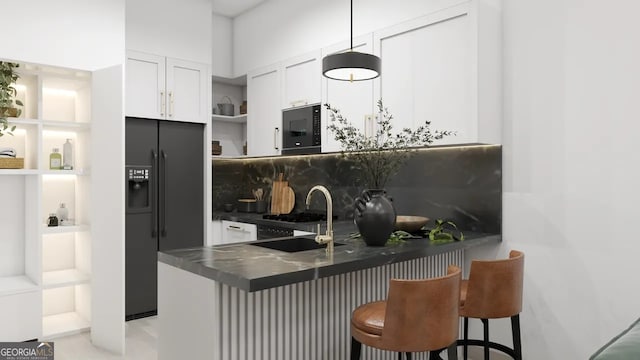 kitchen featuring kitchen peninsula, sink, white cabinetry, black appliances, and a breakfast bar area