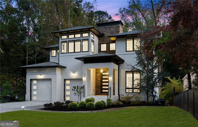 view of front facade featuring a garage and a lawn