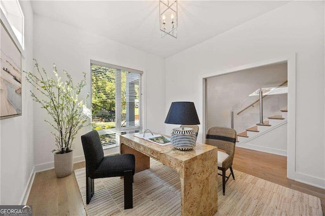 office featuring light wood-type flooring and a notable chandelier