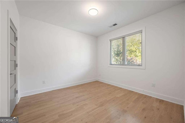 empty room with light hardwood / wood-style flooring