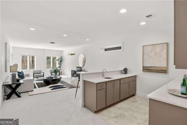 kitchen featuring sink, kitchen peninsula, and a breakfast bar