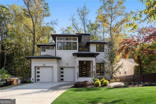 view of front of property featuring a front yard and a garage