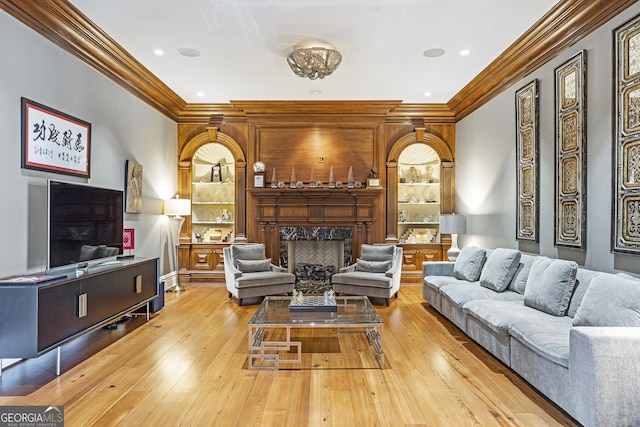 5200 Moore Rd, Suwanee, GA 30024 - living area featuring a fireplace, ornamental molding, built in shelves, wood-type flooring, and recessed lighting