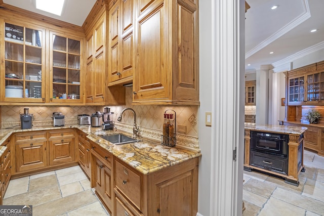 5200 Moore Rd, Suwanee, GA 30024 - kitchen featuring a sink, crown molding, stone tile floors, tasteful backsplash, and light stone countertops