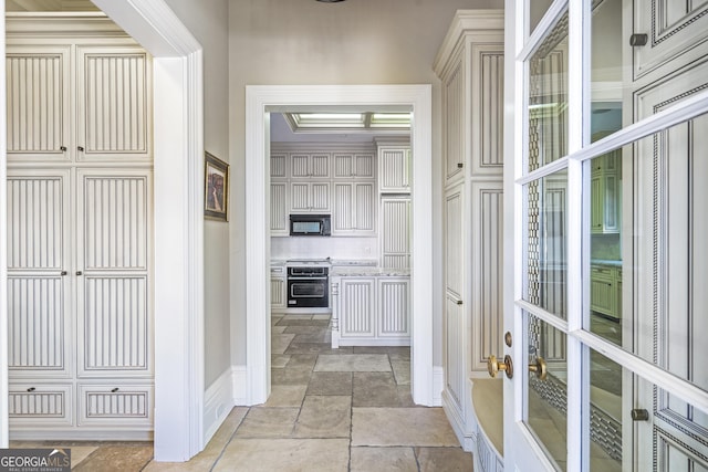 5200 Moore Rd, Suwanee, GA 30024 - corridor featuring baseboards, stone tile floors, and french doors