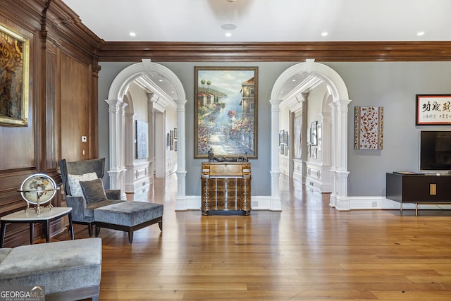 5200 Moore Rd, Suwanee, GA 30024 - living room featuring decorative columns, ornamental molding, hardwood / wood-style floors, arched walkways, and recessed lighting