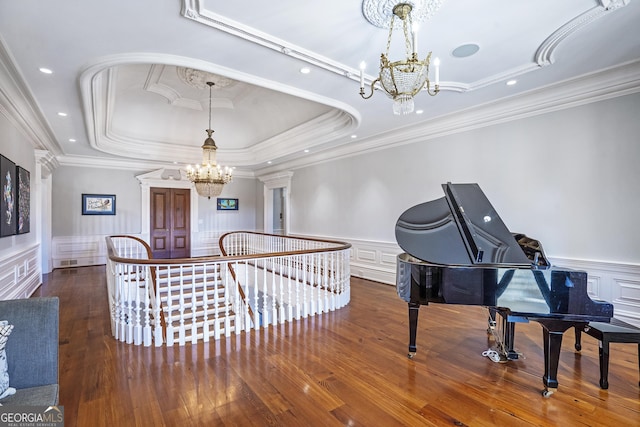 5200 Moore Rd, Suwanee, GA 30024 - living area with a chandelier, a tray ceiling, an upstairs landing, crown molding, and wainscoting