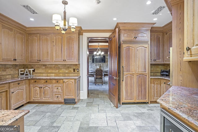 5200 Moore Rd, Suwanee, GA 30024 - kitchen with a chandelier, paneled fridge, tasteful backsplash, light stone countertops, and recessed lighting