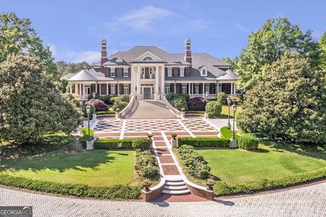 5200 Moore Rd, Suwanee, GA 30024 - neoclassical home featuring a front yard and a chimney