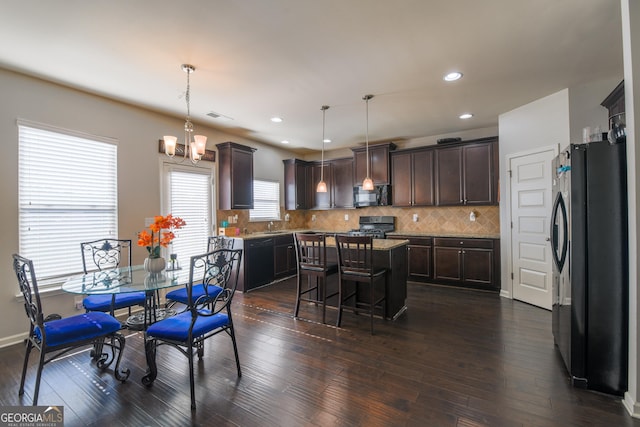 dining area with a notable chandelier and dark hardwood / wood-style floors