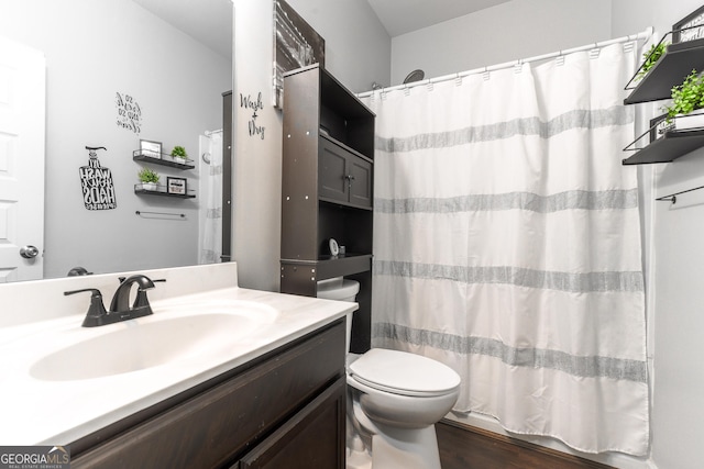 full bathroom featuring shower / bath combo with shower curtain, wood-type flooring, toilet, and vanity