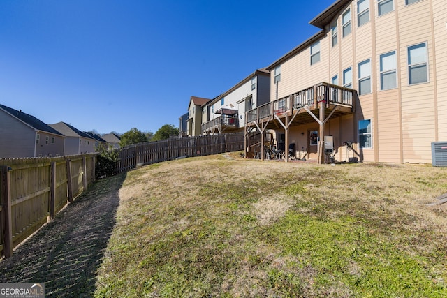 view of yard featuring a deck and central air condition unit