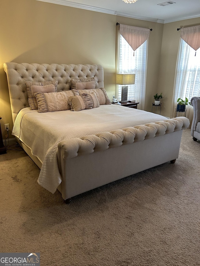 bedroom featuring crown molding and carpet