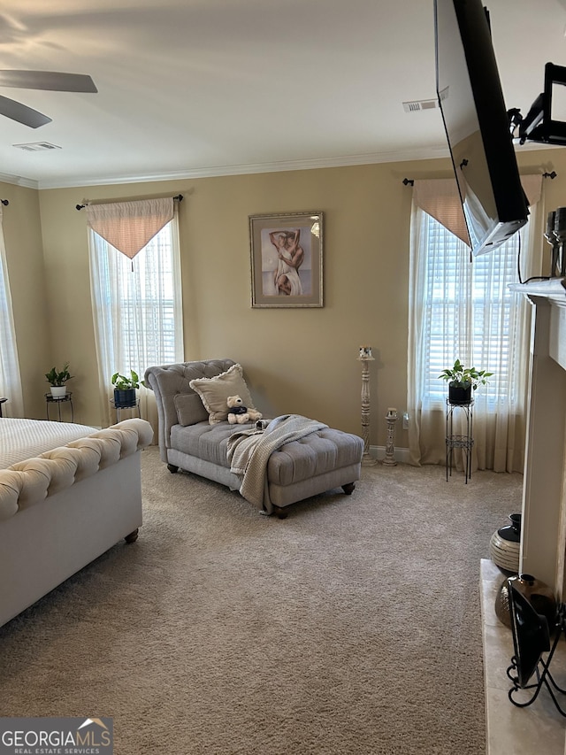 carpeted bedroom featuring crown molding and ceiling fan