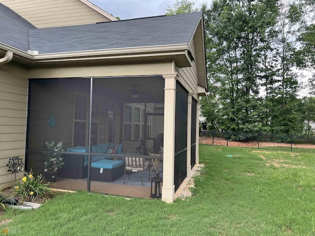 exterior space featuring a lawn and a sunroom