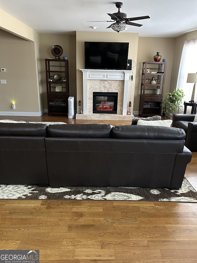 living room featuring hardwood / wood-style flooring and ceiling fan