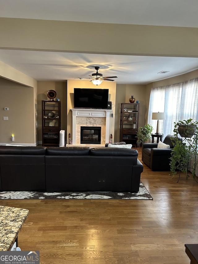 living room featuring hardwood / wood-style floors and ceiling fan