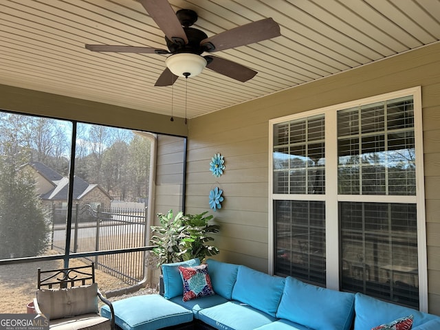 unfurnished sunroom featuring ceiling fan