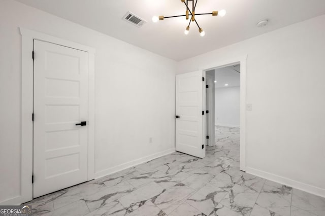 empty room featuring a notable chandelier