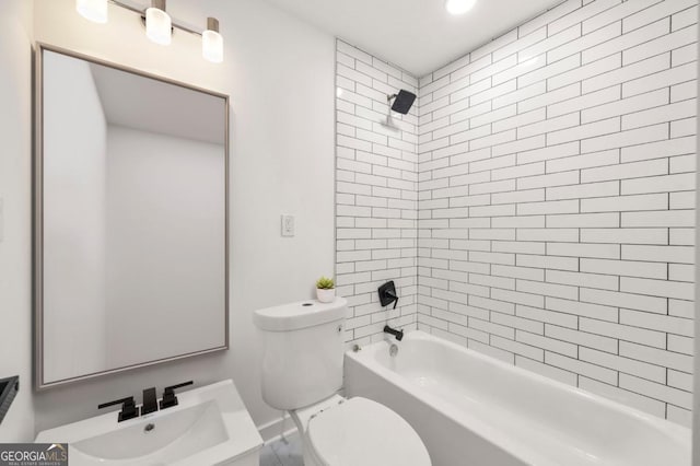 full bathroom with toilet, tiled shower / bath, and vanity