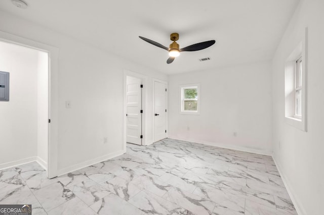 unfurnished room featuring ceiling fan and electric panel