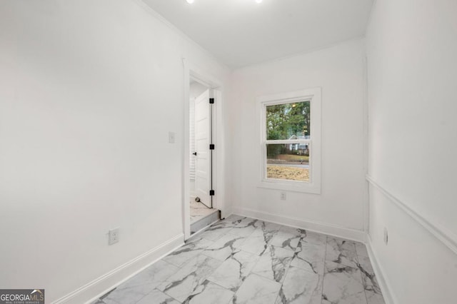 unfurnished room featuring crown molding