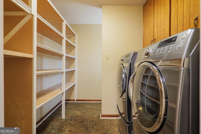 washroom with a textured ceiling, washer and dryer, and dark carpet