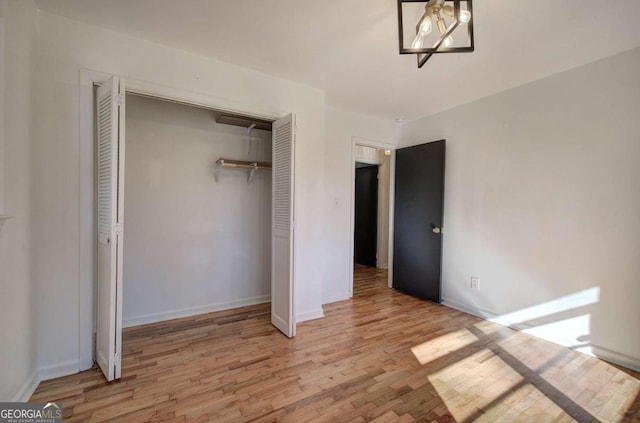 unfurnished bedroom featuring a closet and light hardwood / wood-style flooring