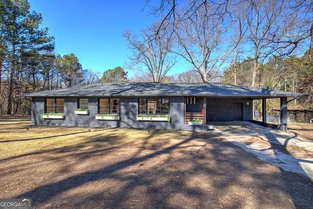 single story home with a carport and a front lawn