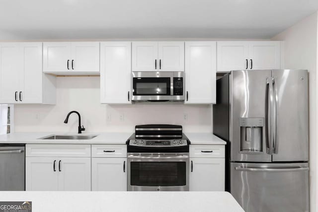 kitchen featuring sink, white cabinetry, and appliances with stainless steel finishes