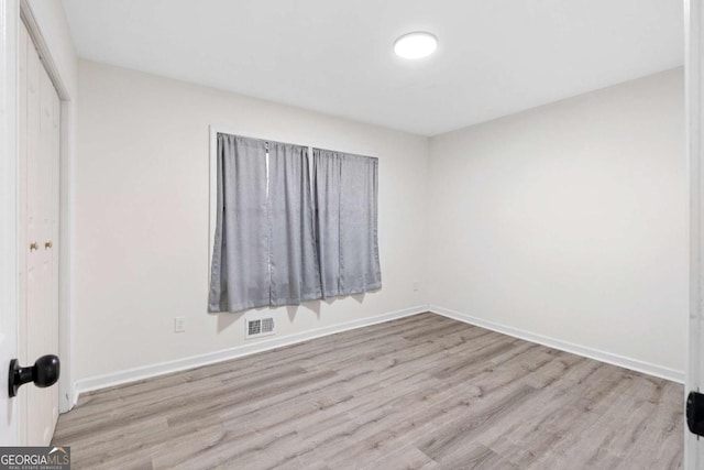 unfurnished room featuring light hardwood / wood-style floors