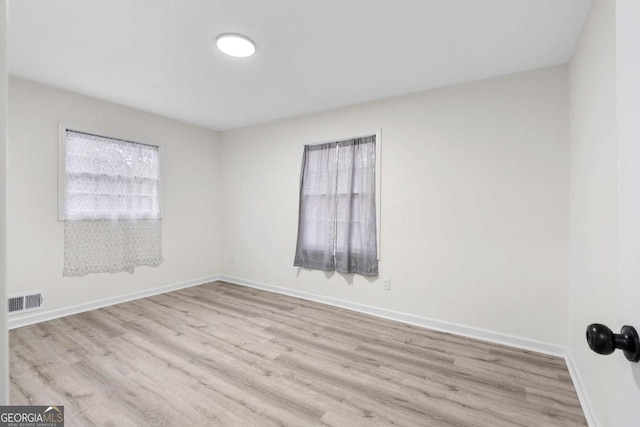 spare room with light hardwood / wood-style floors