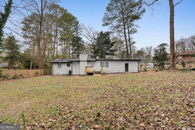 rear view of property featuring a yard