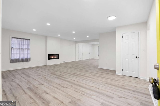 unfurnished living room with light hardwood / wood-style flooring