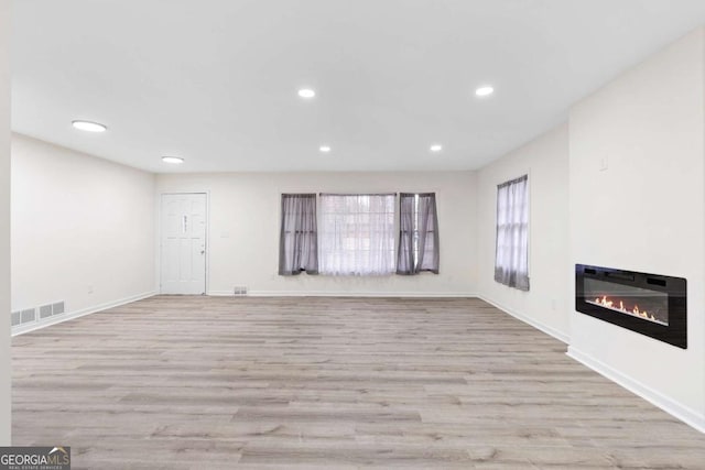 unfurnished living room with light hardwood / wood-style floors