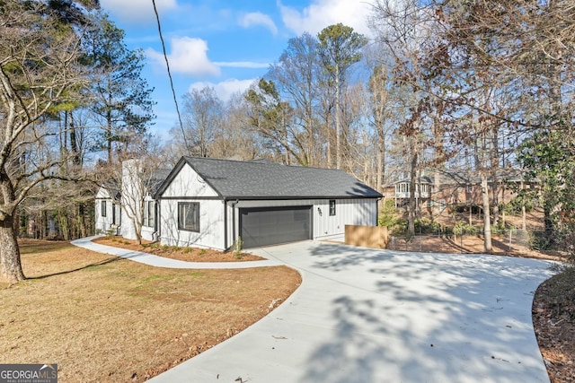 view of front of home with a front yard and a garage