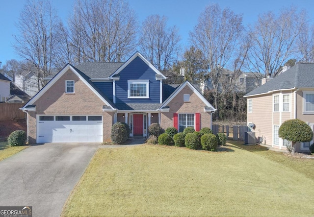 view of front of property with a garage, cooling unit, and a front lawn