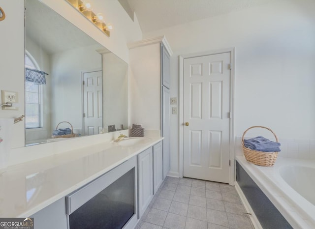 bathroom with vanity, tile patterned flooring, and a bathing tub