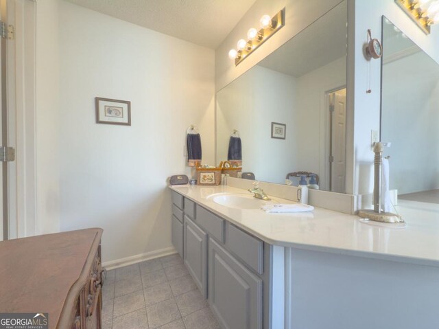 bathroom featuring vanity and a textured ceiling