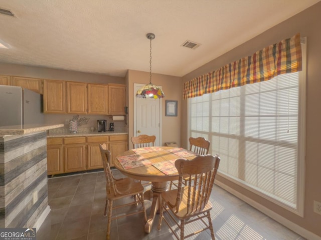 dining room with dark tile patterned floors