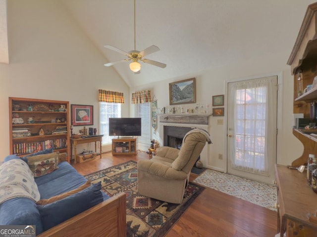 living room with ceiling fan, high vaulted ceiling, and hardwood / wood-style floors