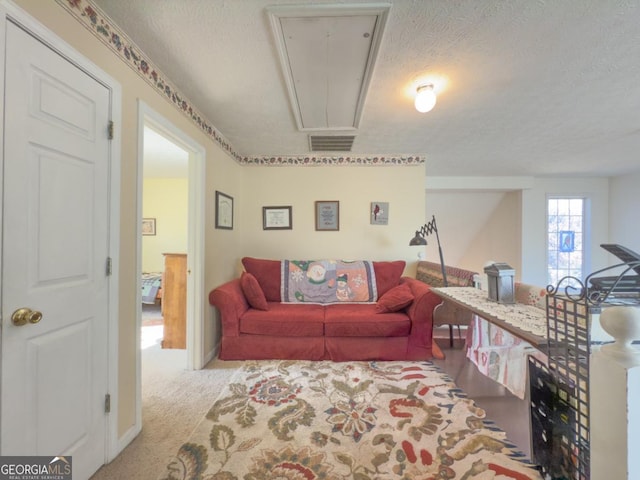 carpeted living room with a textured ceiling